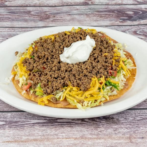 Tequila Lopez Mexican Restaurant's tostada with ground beef, shredded lettuce, cheese, and sour cream.